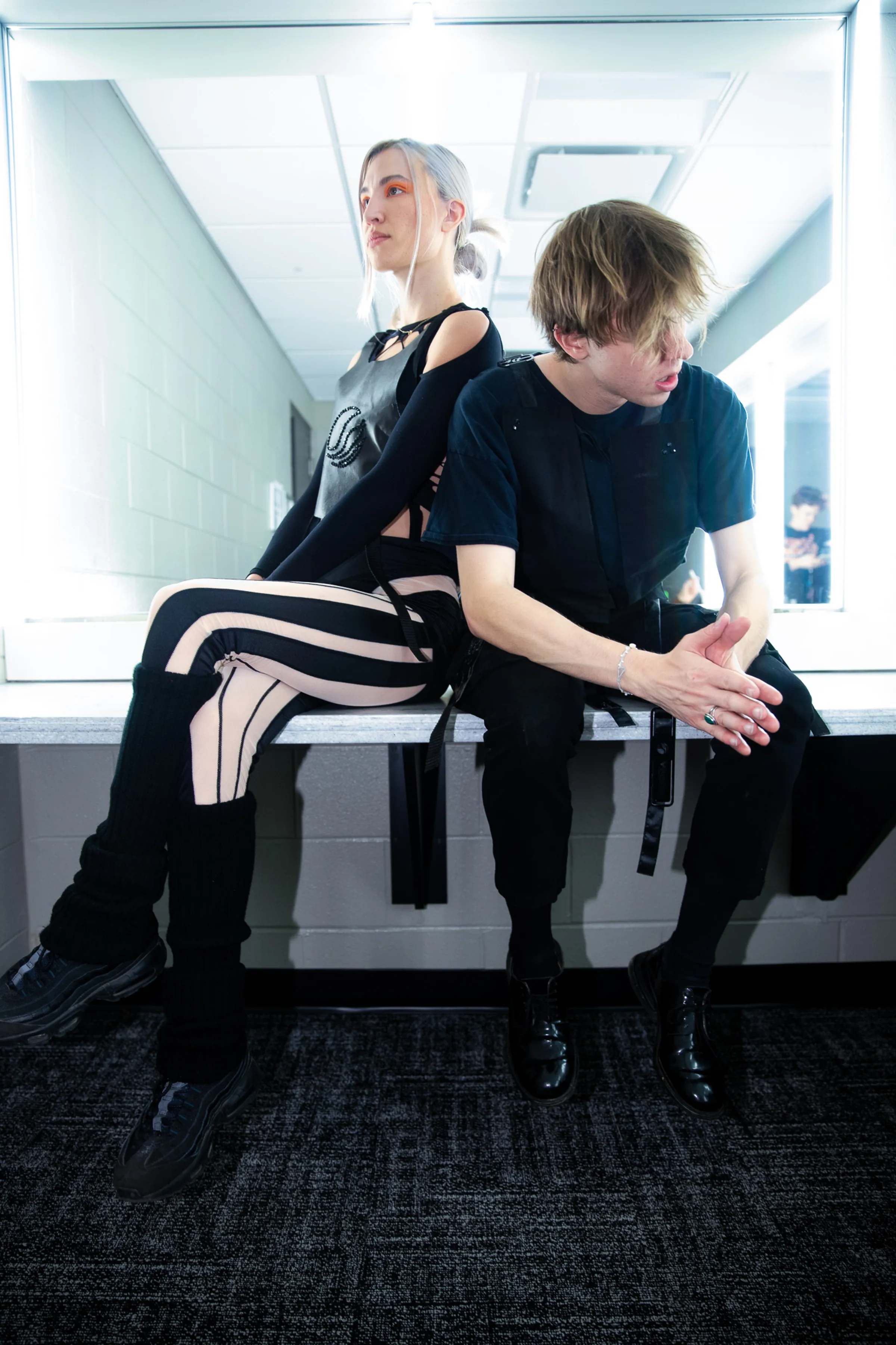 Backstage portrait of two performers in black Mersia garments.