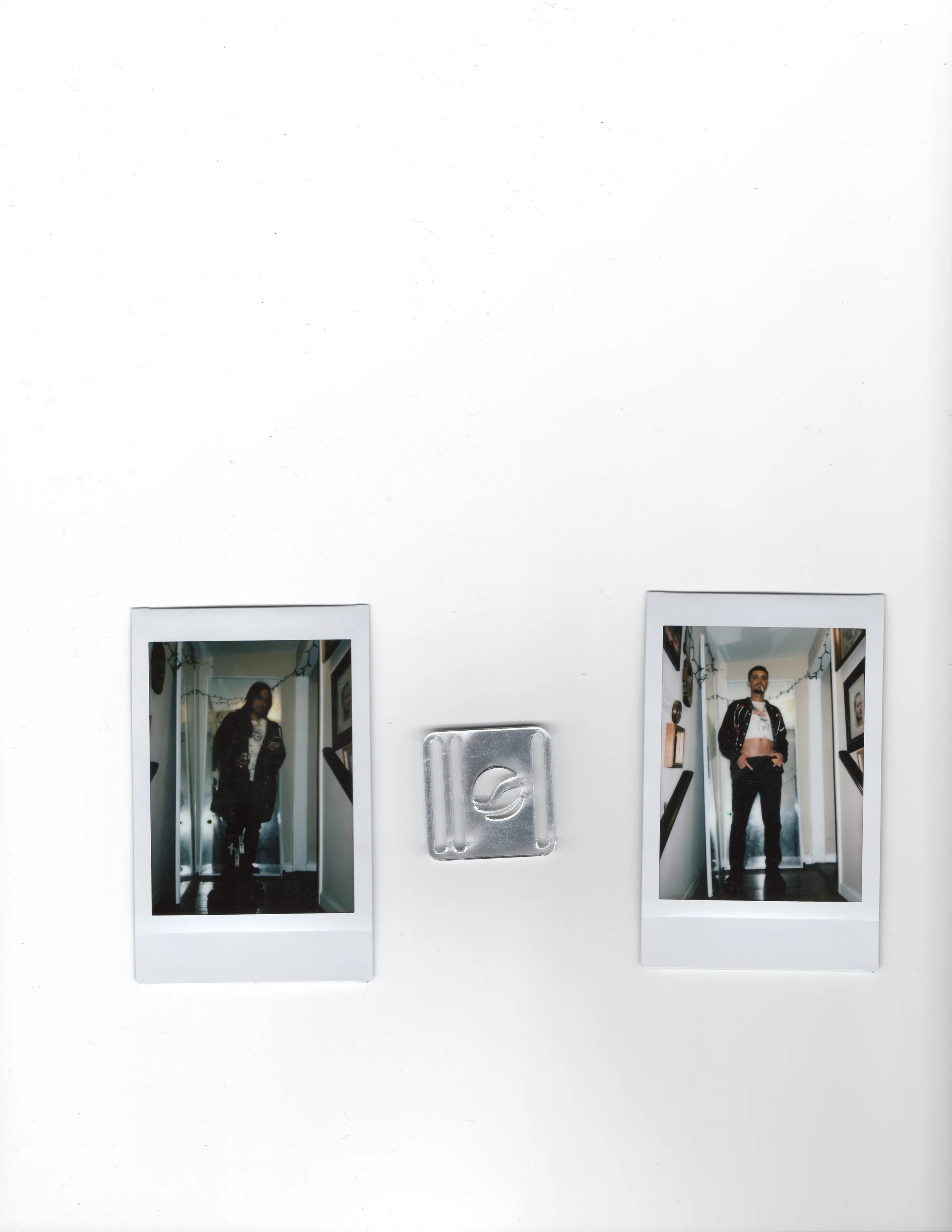 Two Polaroids and a silver Mersia logo buckle on a white scanner bed.