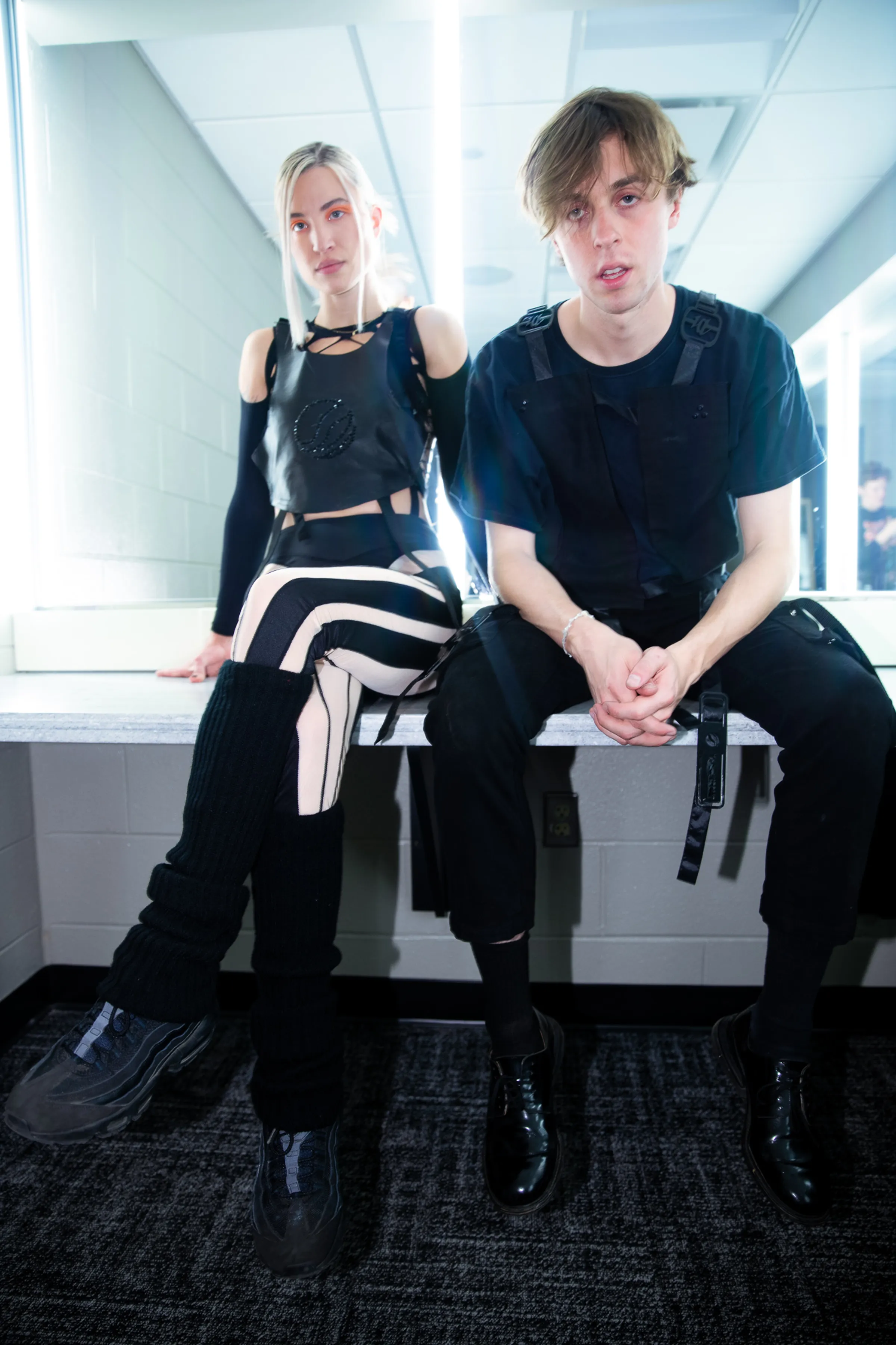 Two performers backstage wearing black Mersia stage garments.