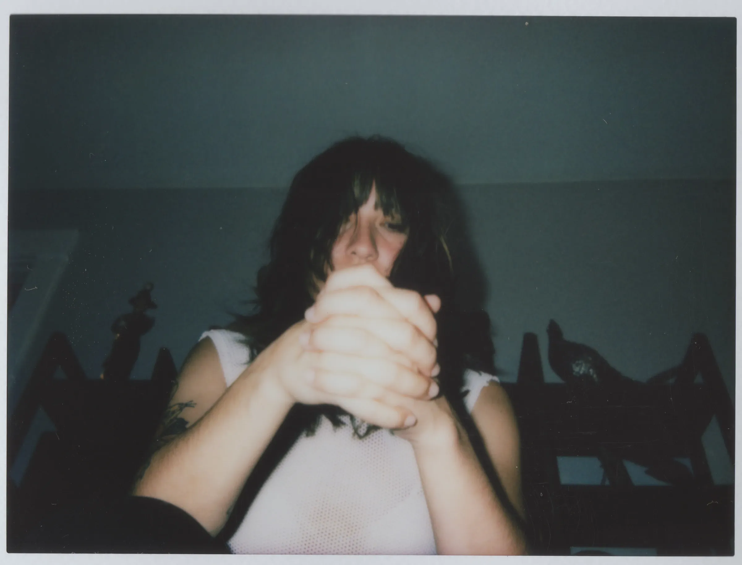 Tanukichan holding hands with another person in a flash photograph.