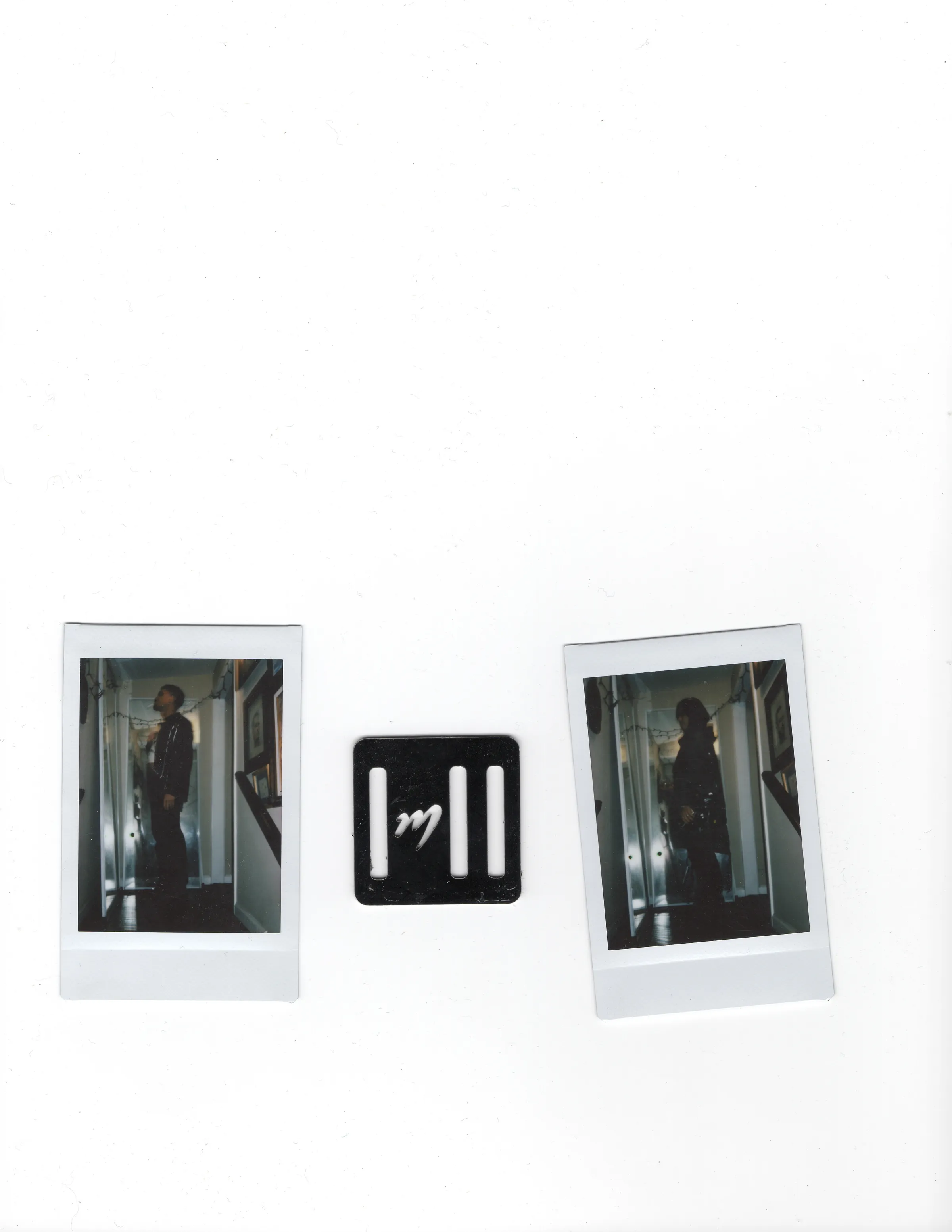 Two Polaroids flanking a black Mersia buckle on a white scanner bed.