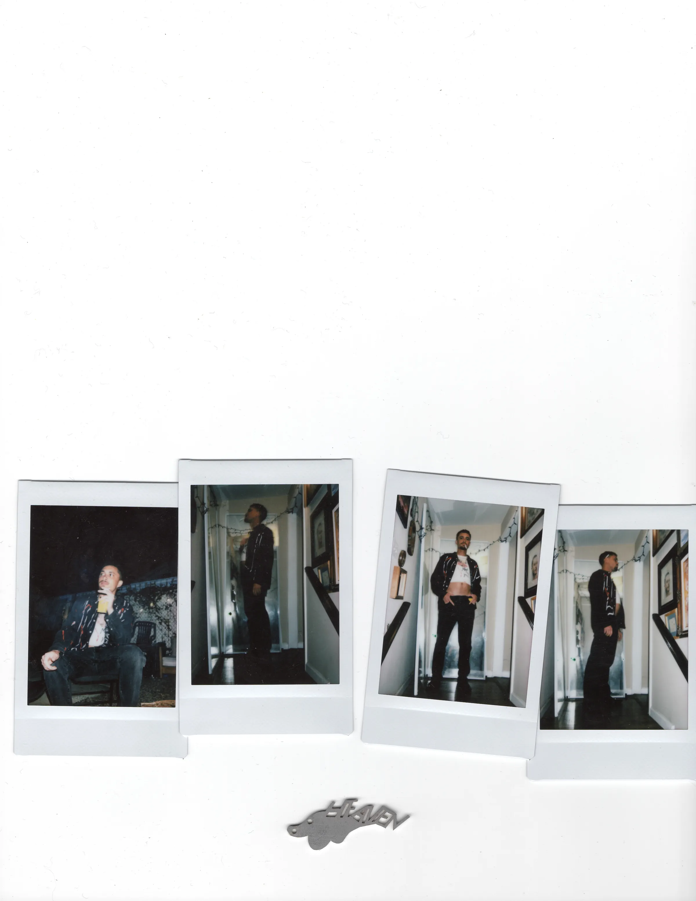 Four Polaroids lined up above a small metal Heaven artifact.