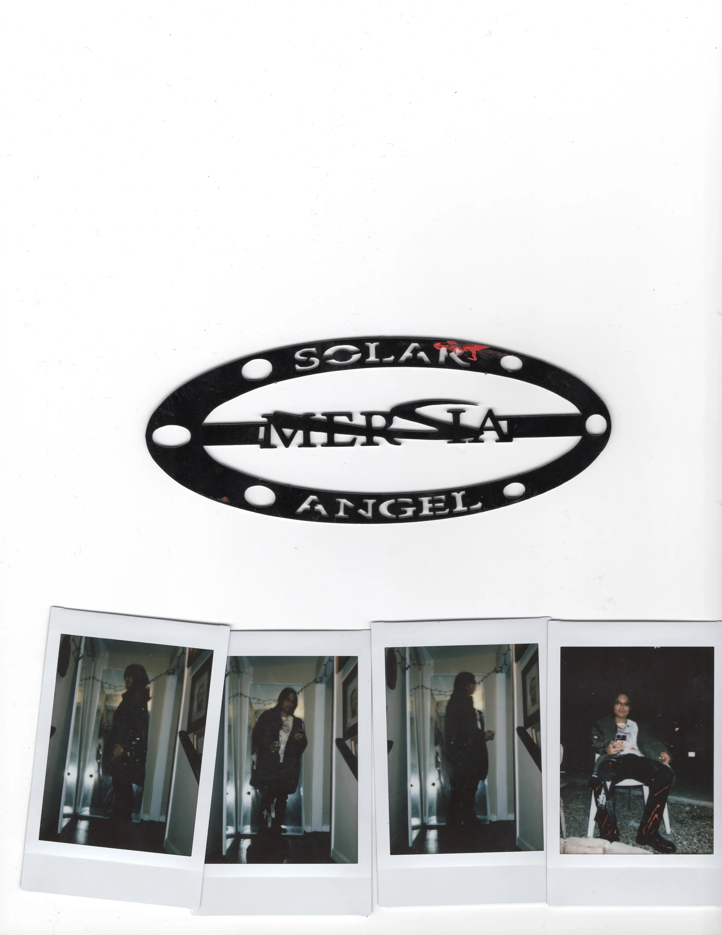 Black Solar Angel hardware and a row of four Polaroids.