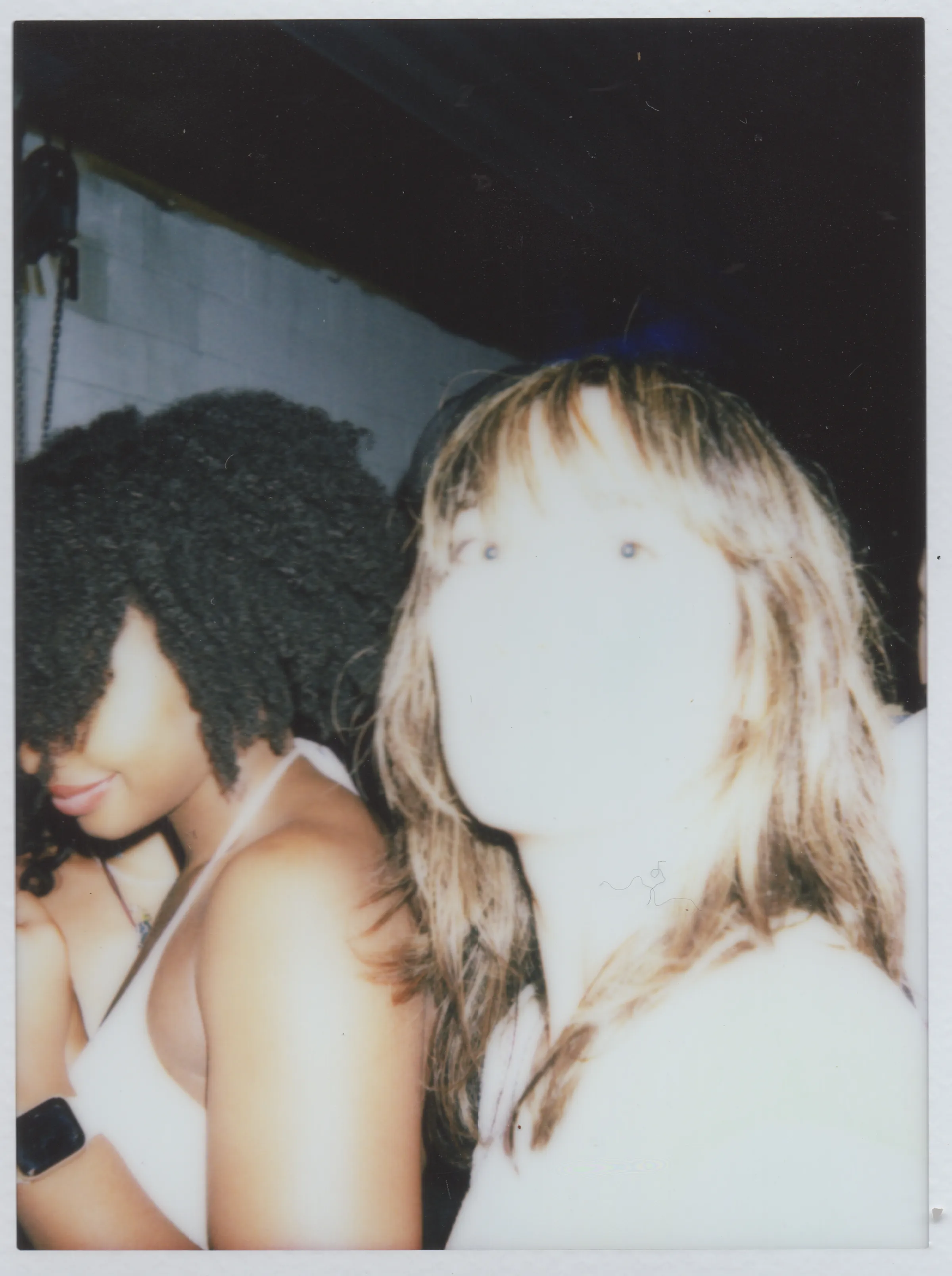 Overexposed flash portrait of two people at night.