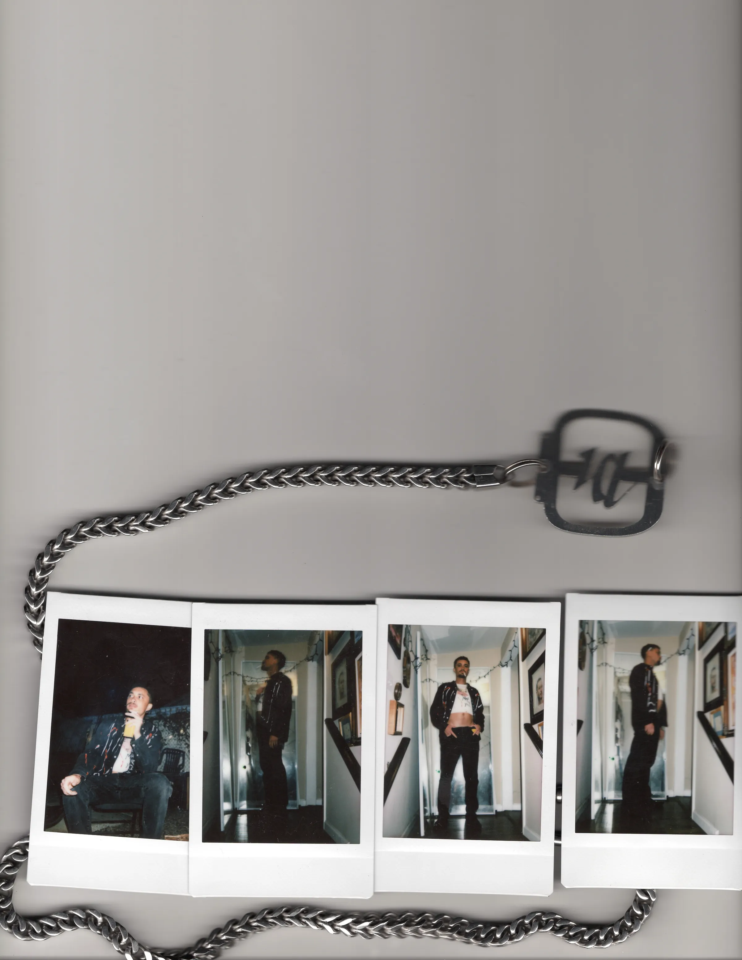 A silver chain and Mersia locket encircling four Polaroids.